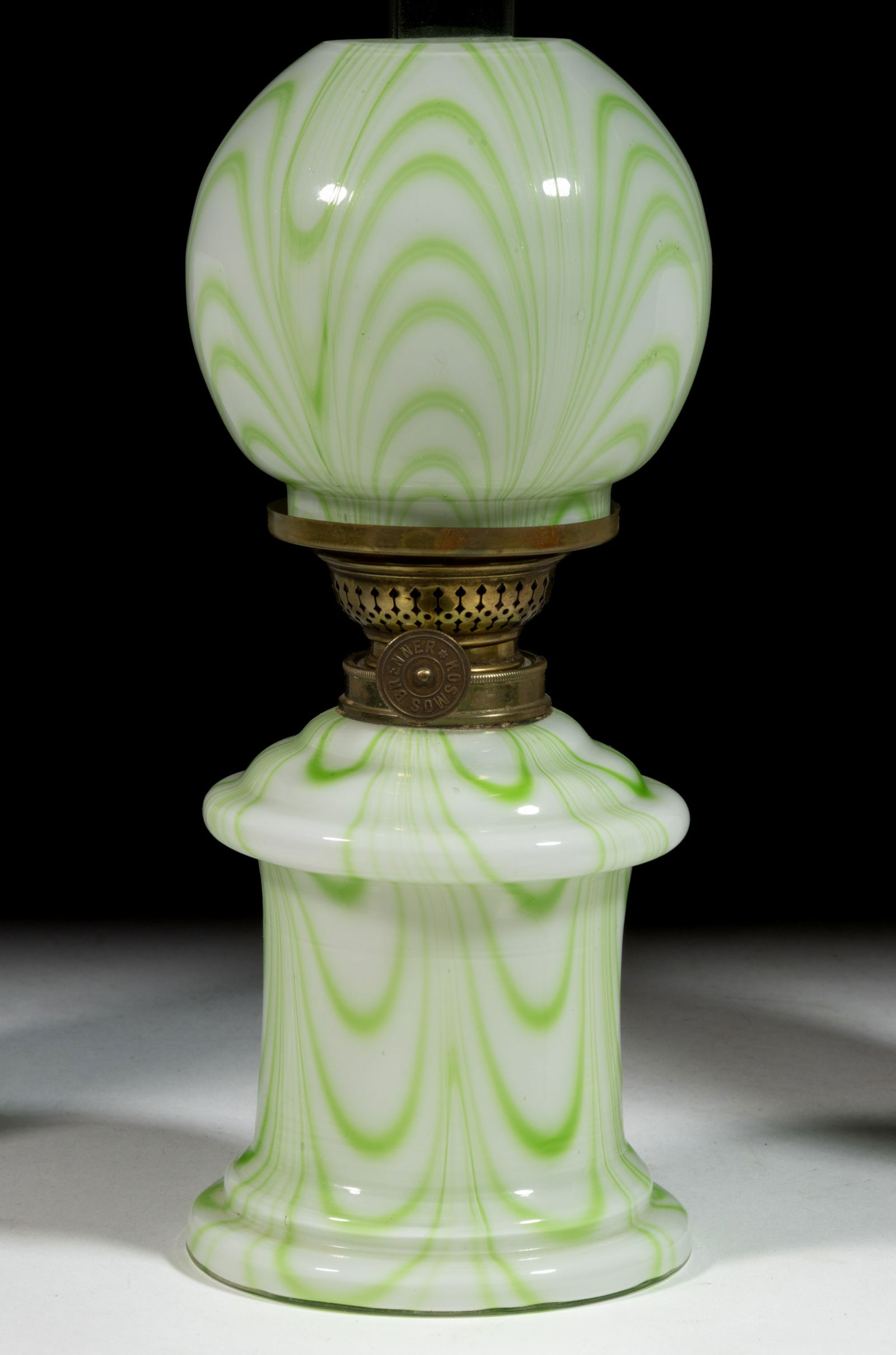 LOOP CASED GLASS MINIATURE LAMP: LOOP CASED GLASS MINIATURE LAMP, opal with apple-green loopings, cylinder-form font with wide concave medial band, ringed shoulder and base, matching patterned ball-form shade, period collar. Fitted w