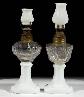 ASSORTED PATTERNED MINIATURE STAND LAMPS, LOT OF TWO: ASSORTED PATTERNED MINIATURE STAND LAMPS, LOT OF TWO, comprising of a Looped Zipper and a Fleur de lys examples, colorless blown-molded globular-form fonts, each having a pressed opaque white base, he