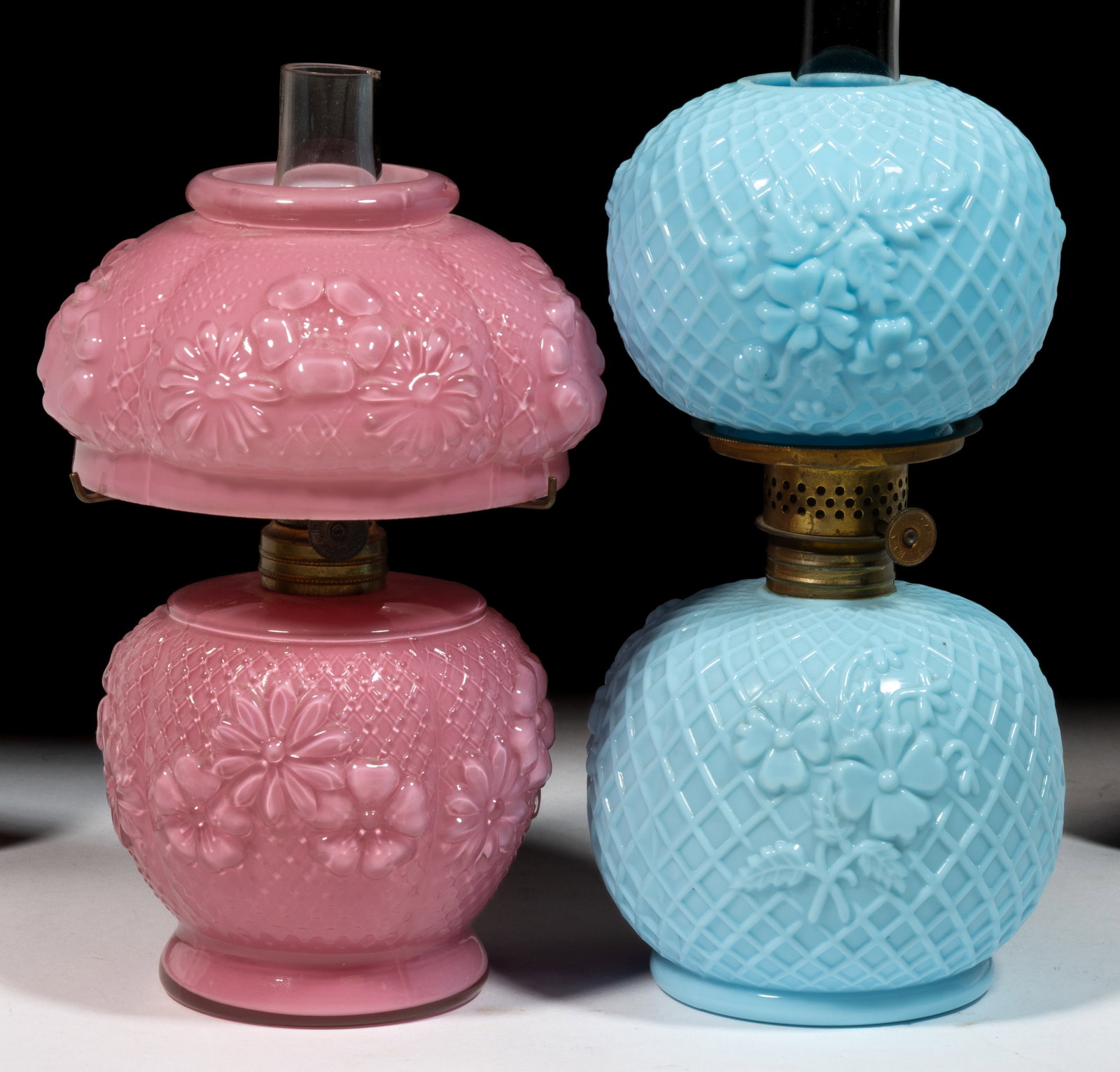 ASSORTED EMBOSSED LATTICE AND FLORAL PATTERNED MINIATURE LAMPS, LOT OF TWO: ASSORTED EMBOSSED LATTICE AND FLORAL PATTERNED MINIATURE LAMPS, LOT OF TWO, comprising an opaque blue Margeurite/Smith I, fig. 229 and a cased pink/rose Cosmos/Smith I, fig. 286; each with a matching 