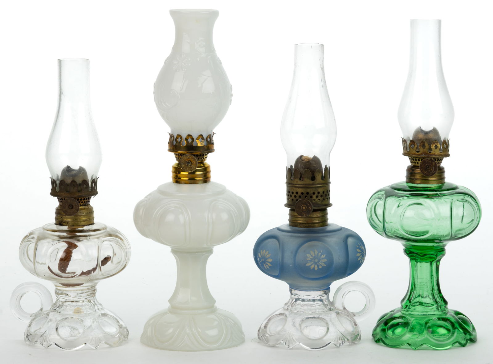 ASSORTED BULLSEYE PATTERNED MINIATURE LAMPS, LOT OF FOUR: ASSORTED BULLSEYE PATTERNED MINIATURE LAMPS, LOT OF FOUR, colorless, green, and opaque white, comprising of two footed finger and a stand Daisy/Smith I, fig. 112 examples, including one with blue sati