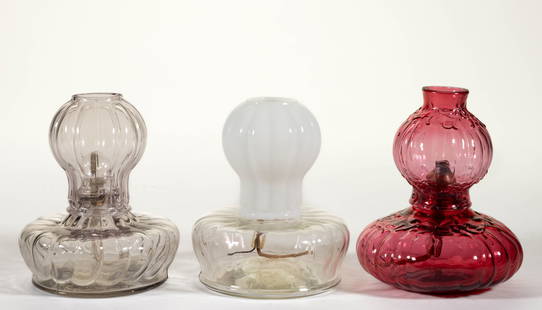 ASSORTED PATTERNED MINIATURE GLOW LAMPS, LOT OF THREE: ASSORTED PATTERNED MINIATURE GLOW LAMPS, LOT OF THREE, comprising a cased cranberry Smith I, fig. 628 with matching chimney-shade; two colorless Smith I, fig. 625 with one having straight ribs and rem
