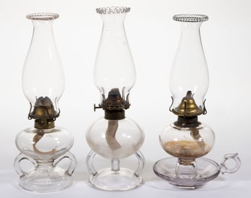 ASSORTED PATTERNED KEROSENE FOOTED FINGER LAMPS, LOT OF THREE