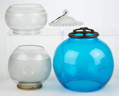 ASSORTED GLASS KEROSENE LAMP SHADES, LOT OF FOUR: ASSORTED GLASS KEROSENE LAMP SHADES, LOT OF FOUR, comprising a colorless and frosted compressed globular-form example, engraved criss-cross and petal pattern, and a 5" D fitter; a colorless and froste