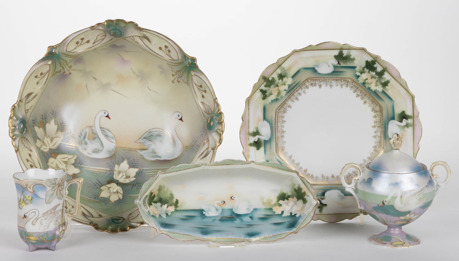 R.S. PRUSSIA AND OTHER STYLIZED SWAN MOTIF TEA AND TABLE ARTICLES, LOT OF FIVE: R.S. PRUSSIA AND OTHER STYLIZED SWAN MOTIF TEA AND TABLE ARTICLES, LOT OF FIVE, each having satin finish, comprising a Mold 601 pedestalled sugar example depicting a swan amongst waterlilies, a salad 