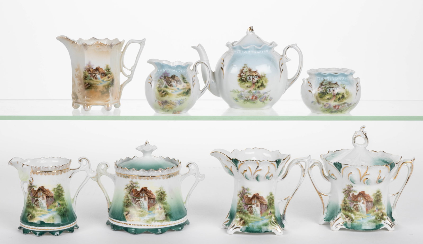 R.S. PRUSSIA AND OTHER PORCELAIN SCENIC MOTIF TEA ARTICLES, LOT OF EIGHT: R.S. PRUSSIA AND OTHER PORCELAIN SCENIC MOTIF TEA ARTICLES, LOT OF EIGHT, each having polychrome transfer scene, comprising five examples featuring mill image with waterwheel including a six-footed pa