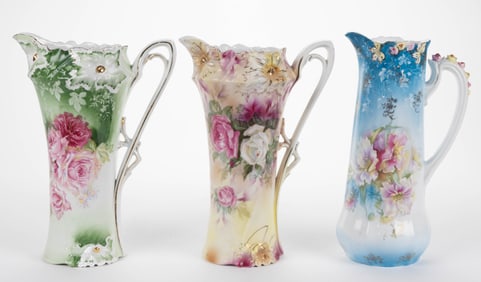 R.S. PRUSSIA PORCELAIN FLORAL MOTIF TANKARDS, LOT OF THREE