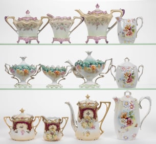 R.S. PRUSSIA PORCELAIN FLORAL MOTIF THREE-PIECE DRINKING SETS, LOT OF FOUR