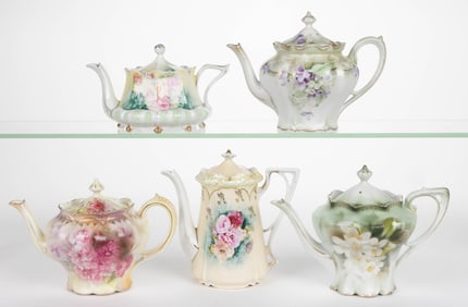R.S. PRUSSIA PORCELAIN FLORAL MOTIF TEAPOTS, LOT OF FIVE