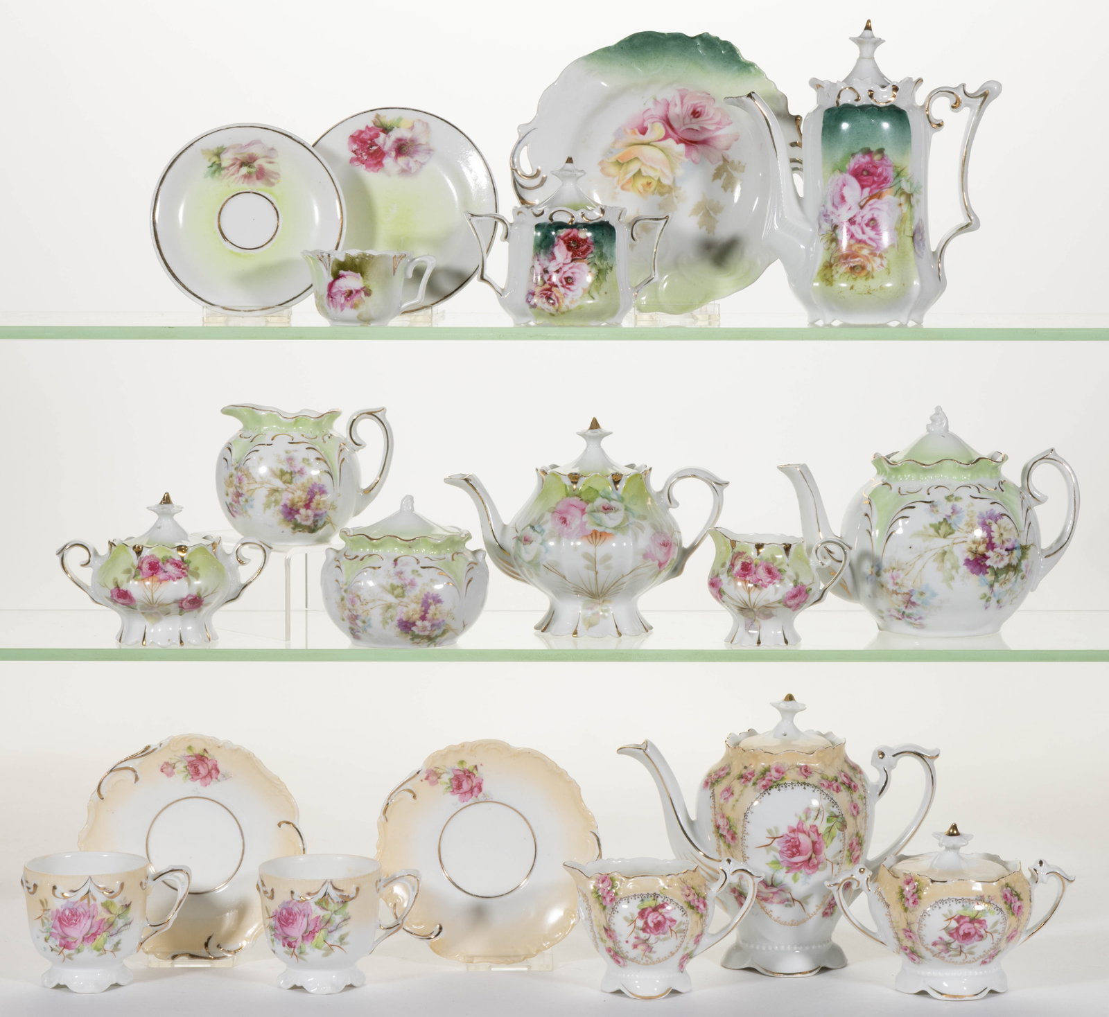 R.S. PRUSSIA PORCELAIN FLORAL MOTIF CHILDREN'S TEA ARTICLES, LOT OF 19: R.S. PRUSSIA PORCELAIN FLORAL MOTIF CHILDREN'S TEA ARTICLES, LOT OF 19, each having polychrome transfer images, comprising a six-piece set having scalloped foot having pink rose motif with tan accents
