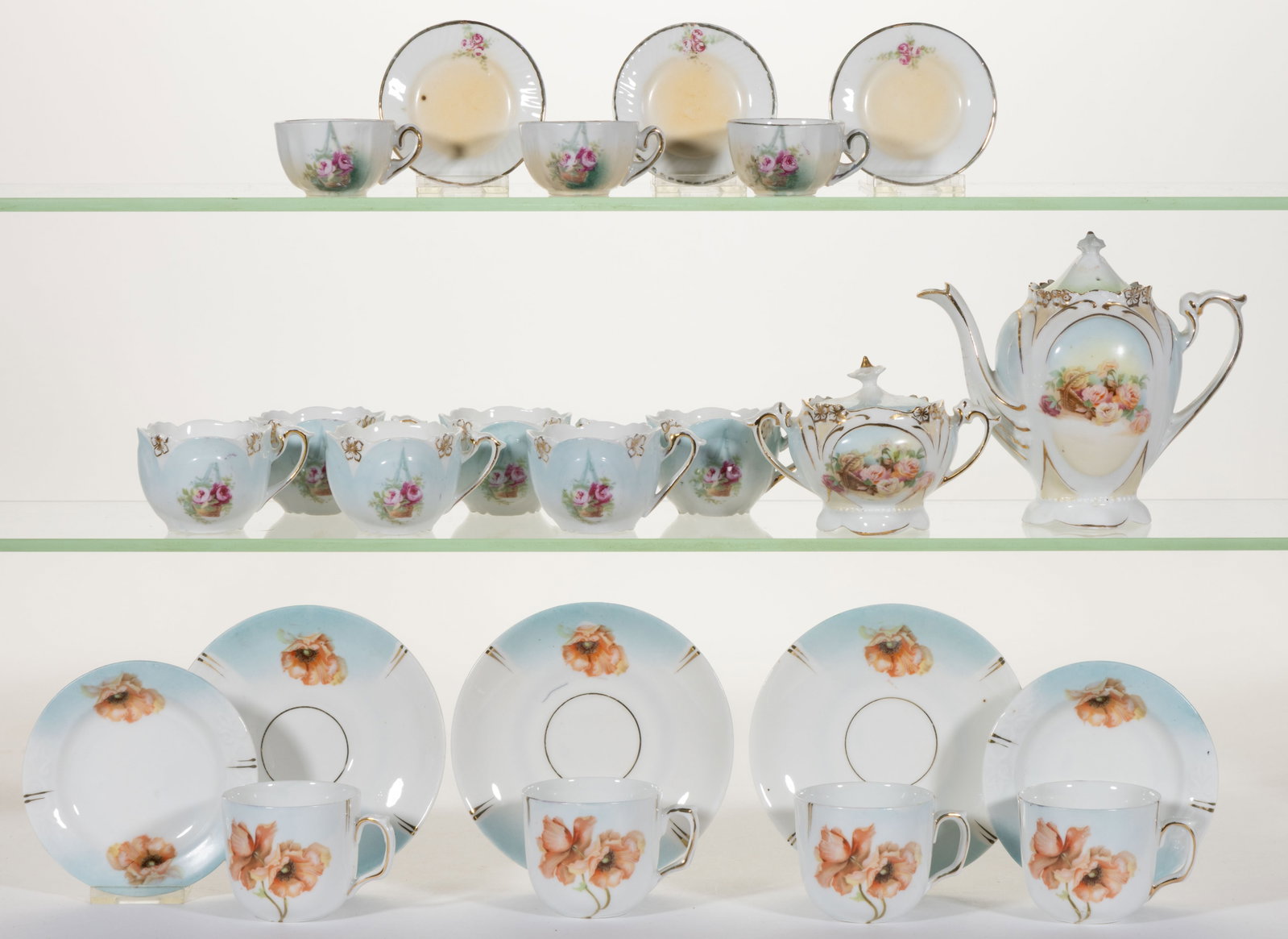 R.S. PRUSSIA PORCELAIN FLORAL MOTIF CHILDREN'S TOY TEA ARTICLES, LOT OF 23: R.S. PRUSSIA PORCELAIN FLORAL MOTIF CHILDREN'S TOY TEA ARTICLES, LOT OF 23, each having polychrome transfer images, including a teapot (cover probably together by association) and covered sugar having