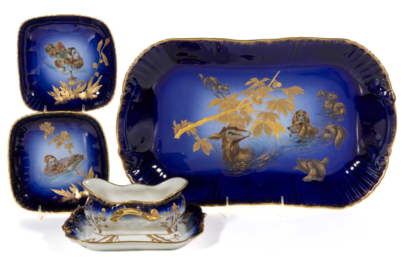 FRENCH LIMOGES PORCELAIN COBALT-DECORATED HAND-PAINTED GAME MOTIF TABLE ARTICLES, LOT OF FOUR: FRENCH LIMOGES PORCELAIN COBALT-DECORATED HAND-PAINTED GAME MOTIF TABLE ARTICLES, LOT OF FOUR, each having sponged gilt to cobalt border, comprising a 18 1/2" x 11 1/4" platter depicting a pack of dog