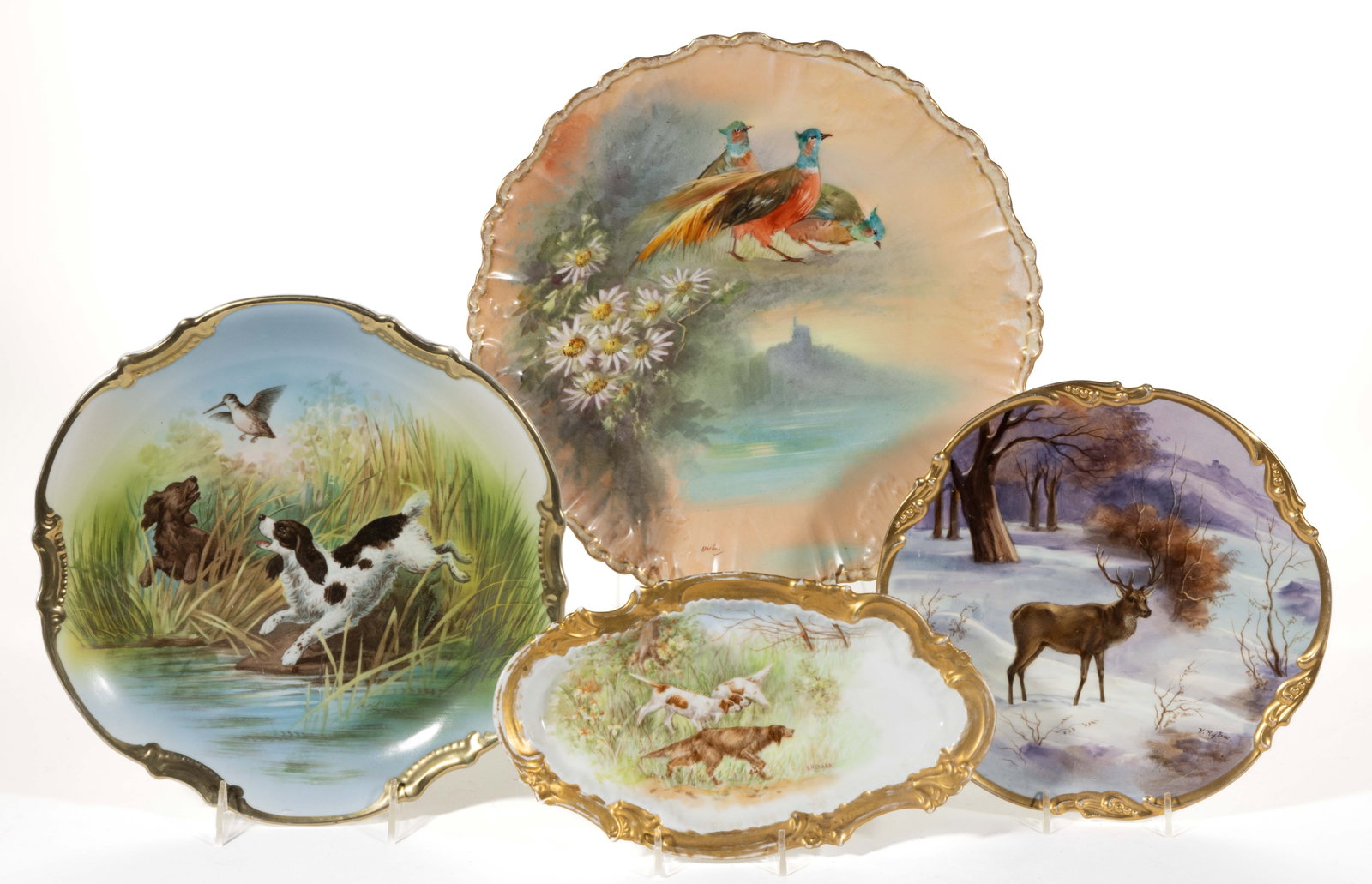 FRENCH LIMOGES / GERMAN PORCELAIN ANIMAL MOTIF ARTICLES, LOT OF FOUR: FRENCH LIMOGES / GERMAN PORCELAIN ANIMAL MOTIF ARTICLES, LOT OF FOUR, comprising a 9 1/2" D plate featuring a stag standing in snow, a charger depicting three bright colored pheasants and daisies to l