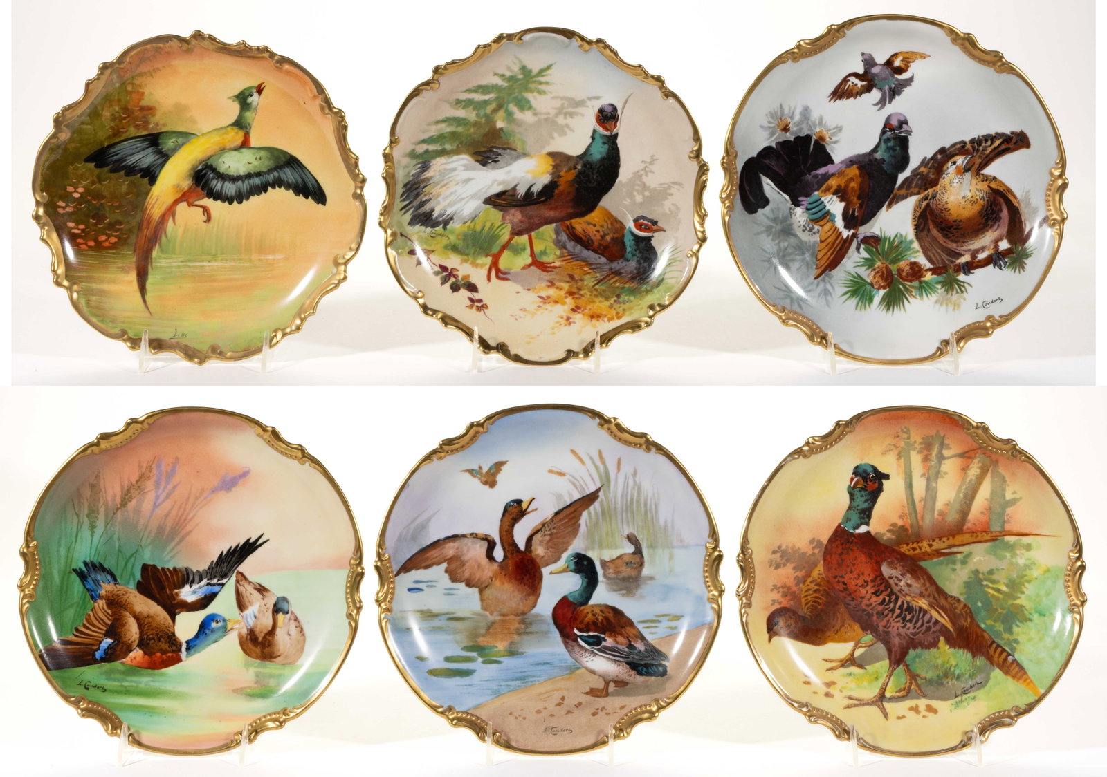FRENCH LIMOGES PORCELAIN HAND-PAINTED GAME BIRD MOTIF PLAQUES, LOT OF SIX: FRENCH LIMOGES PORCELAIN HAND-PAINTED GAME BIRD MOTIF PLAQUES, LOT OF SIX, each having bright polychrome scenes and holes to foot ring for hanging, comprising two examples featuring ducks, one example