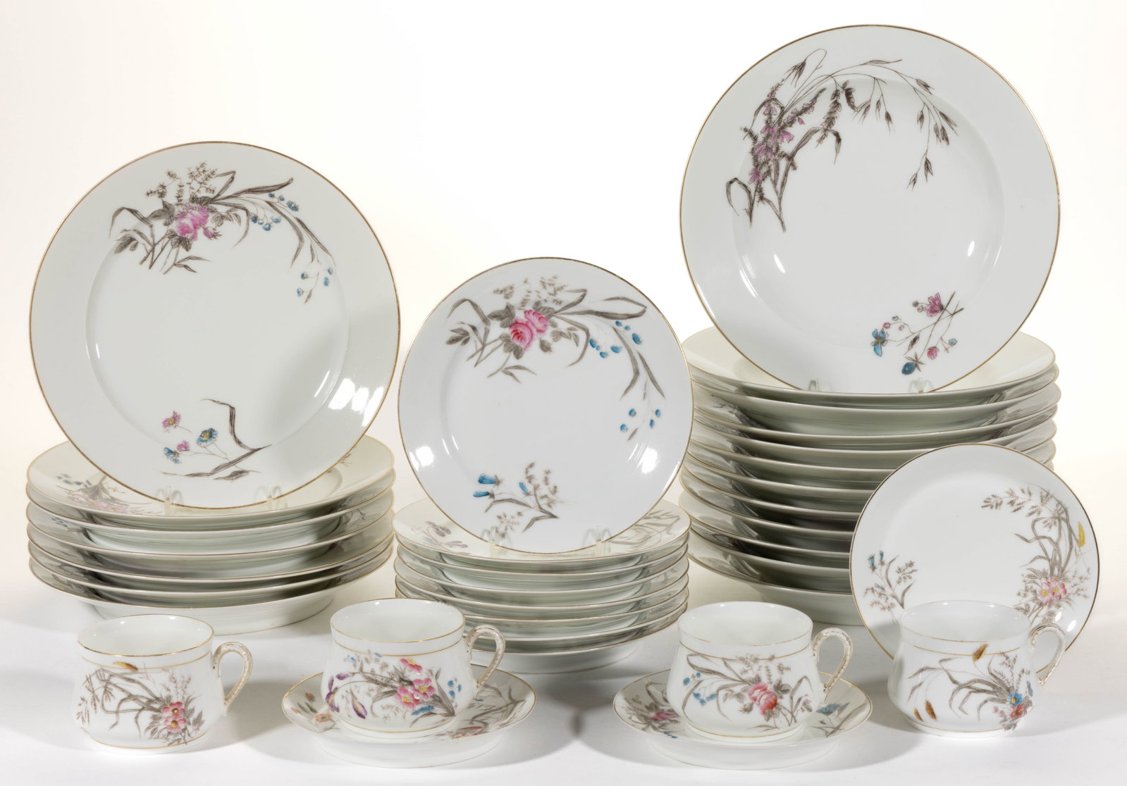 FRENCH HAVILAND LIMOGES PORCELAIN FLORAL MOTIF TABLE ARTICLES, LOT OF 34: FRENCH HAVILAND LIMOGES PORCELAIN FLORAL MOTIF TABLE ARTICLES, LOT OF 34, each having transfer and hand-painted polychrome pink and blue wildflower designs with gilt accents, comprising four soup cups
