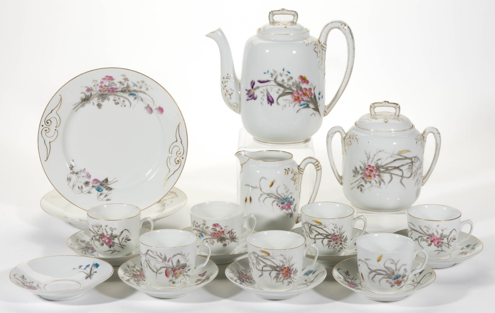 FRENCH HAVILAND LIMOGES PORCELAIN FLORAL MOTIF 20-PIECE COFFEE SET: FRENCH HAVILAND LIMOGES PORCELAIN FLORAL MOTIF 20-PIECE COFFEE SET, each having transfer and hand-painted polychrome pink and blue wildflower designs with gilt accents, comprising a coffee pot, a cove