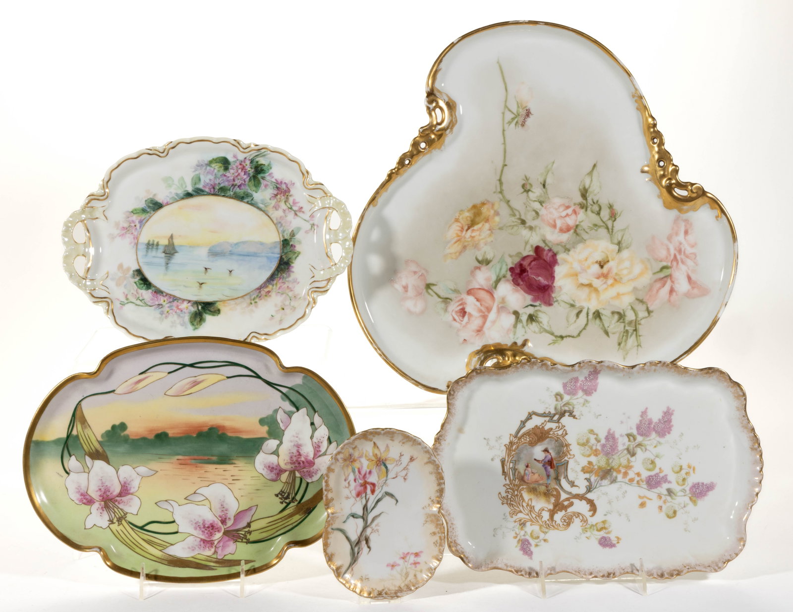 FRENCH LIMOGES PORCELAIN HAND-PAINTED TRAYS, LOT OF FIVE: FRENCH LIMOGES PORCELAIN HAND-PAINTED TRAYS, LOT OF FIVE, comprising one tri-lobed example with polychrome roses, one having delicate iris-like flower motif, one quadri-lobed example depicting a water