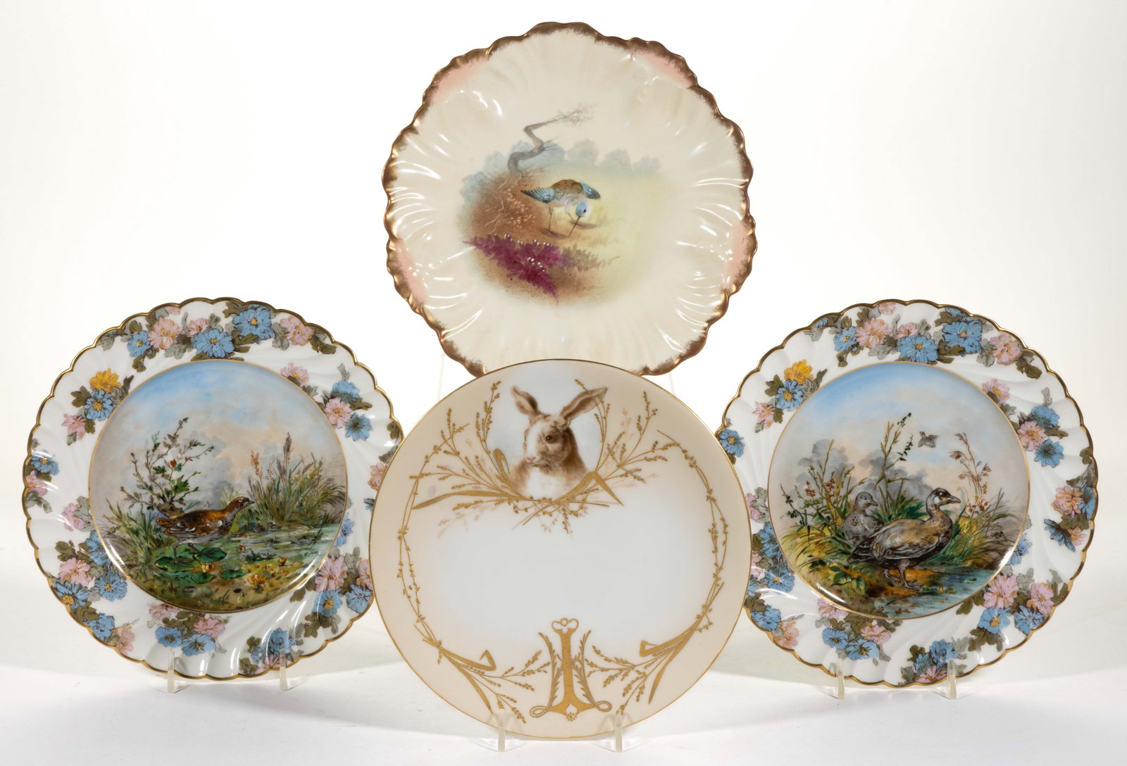 FRENCH LIMOGES PORCELAIN ANIMAL MOTIF PLATES, LOT OF FOUR: FRENCH LIMOGES PORCELAIN ANIMAL MOTIF PLATES, LOT OF FOUR, comprising two hand-painted examples including one featuring a charming rabbit to top framed by raised gilt grass decorations and one depicti