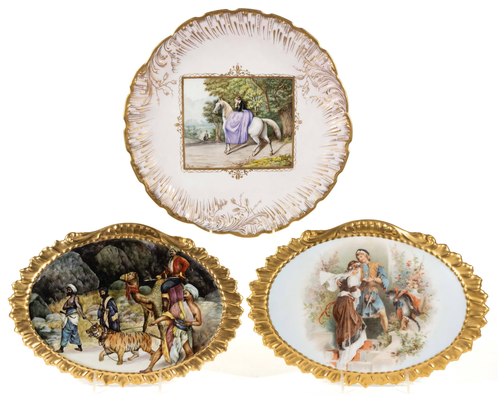 FRENCH LIMOGES PORCELAIN SCENIC MOTIF ARTICLES, LOT OF THREE: FRENCH LIMOGES PORCELAIN SCENIC MOTIF ARTICLES, LOT OF THREE, comprising a polychrome hand-painted charger featuring a woman in a black riding jacket and long purple skirt astride a white horse, signe