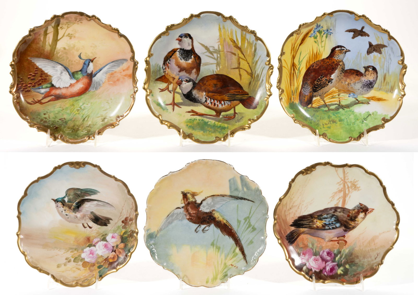 FRENCH LIMOGES PORCELAIN BIRD MOTIF PLAQUES, LOT OF SIX: FRENCH LIMOGES PORCELAIN BIRD MOTIF PLAQUES, LOT OF SIX, each having hole(s) to foot ring for hanging and gilt borders, including game and song birds. Signatures include "L. Coudert", "MAX", and "Dubo