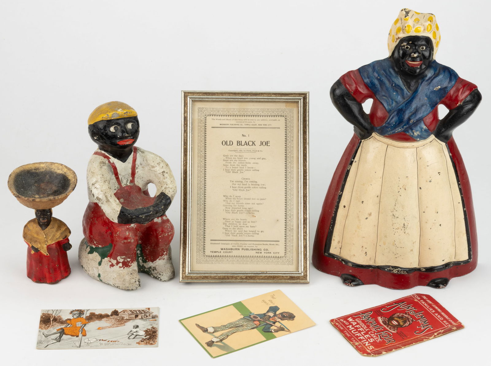 ASSORTED BLACK AMERICANA ARTICLES, LOT OF SEVEN: ASSORTED BLACK AMERICANA ARTICLES, LOT OF SEVEN, comprising a large doorstop; a smaller cast-concrete figure of a boy which may be a doorstop; a small cast-iron figure with a removable basket on her h