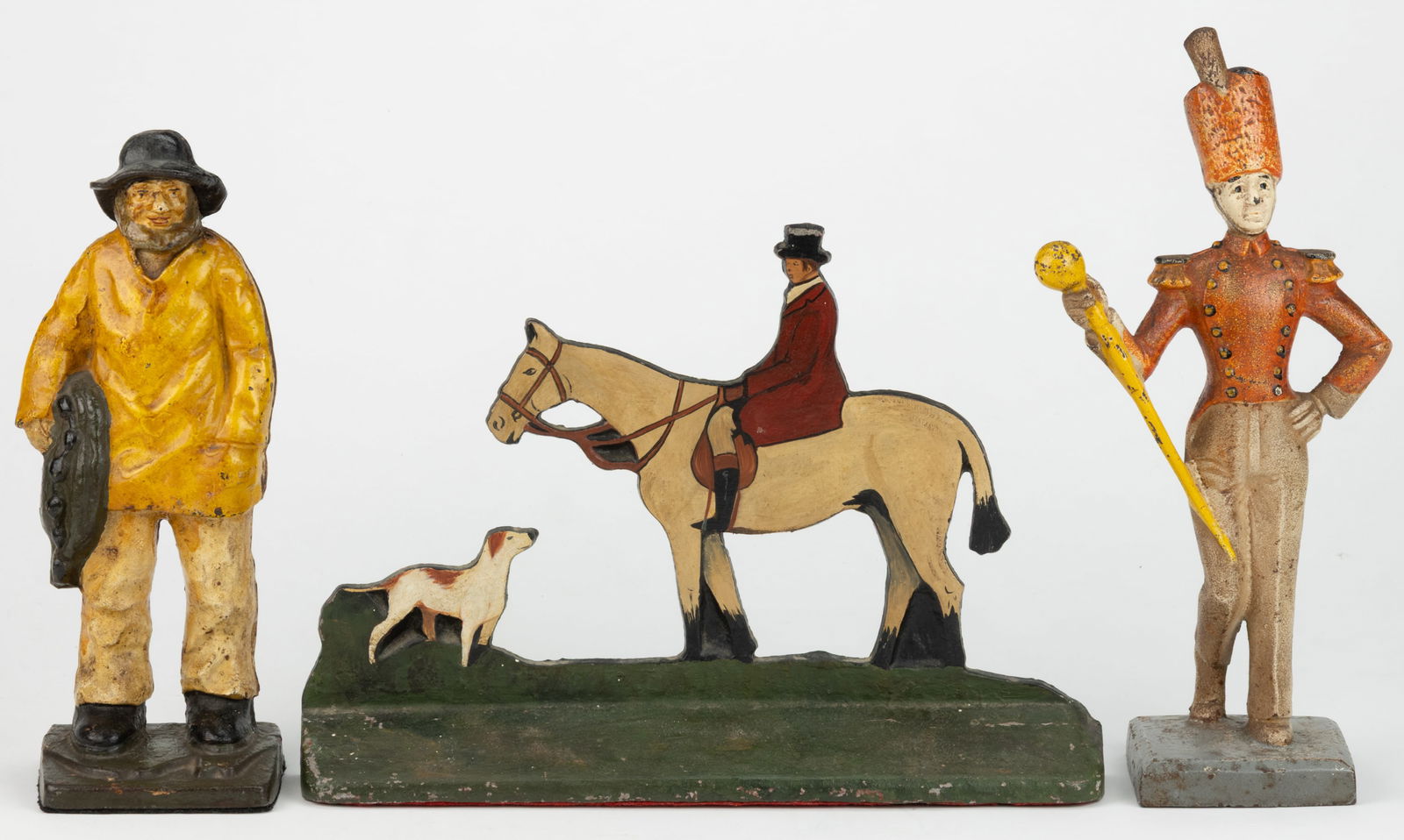 ASSORTED CAST-IRON AND CAST-ALUMINUM DOORSTOPS, LOT OF THREE: ASSORTED CAST-IRON AND CAST-ALUMINUM DOORSTOPS, LOT OF THREE, comprising an "Old Salt" example; a Littco drum major; and an aluminum equestrian fox-hunt example. 20th century. Equestria