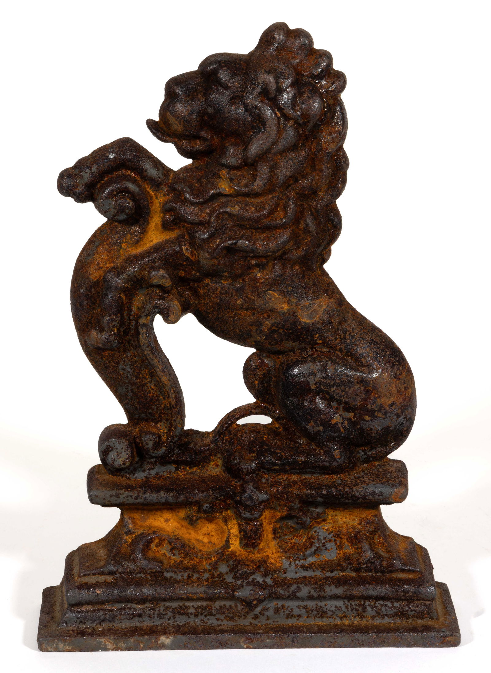 BRITISH CAST-IRON LION DOORSTOP: BRITISH CAST-IRON LION DOORSTOP, of single-sided hollow-cast form, depicting a left facing lion sitting atop a pedestal. Early 20th century. 14" HOA, 10" WOA.