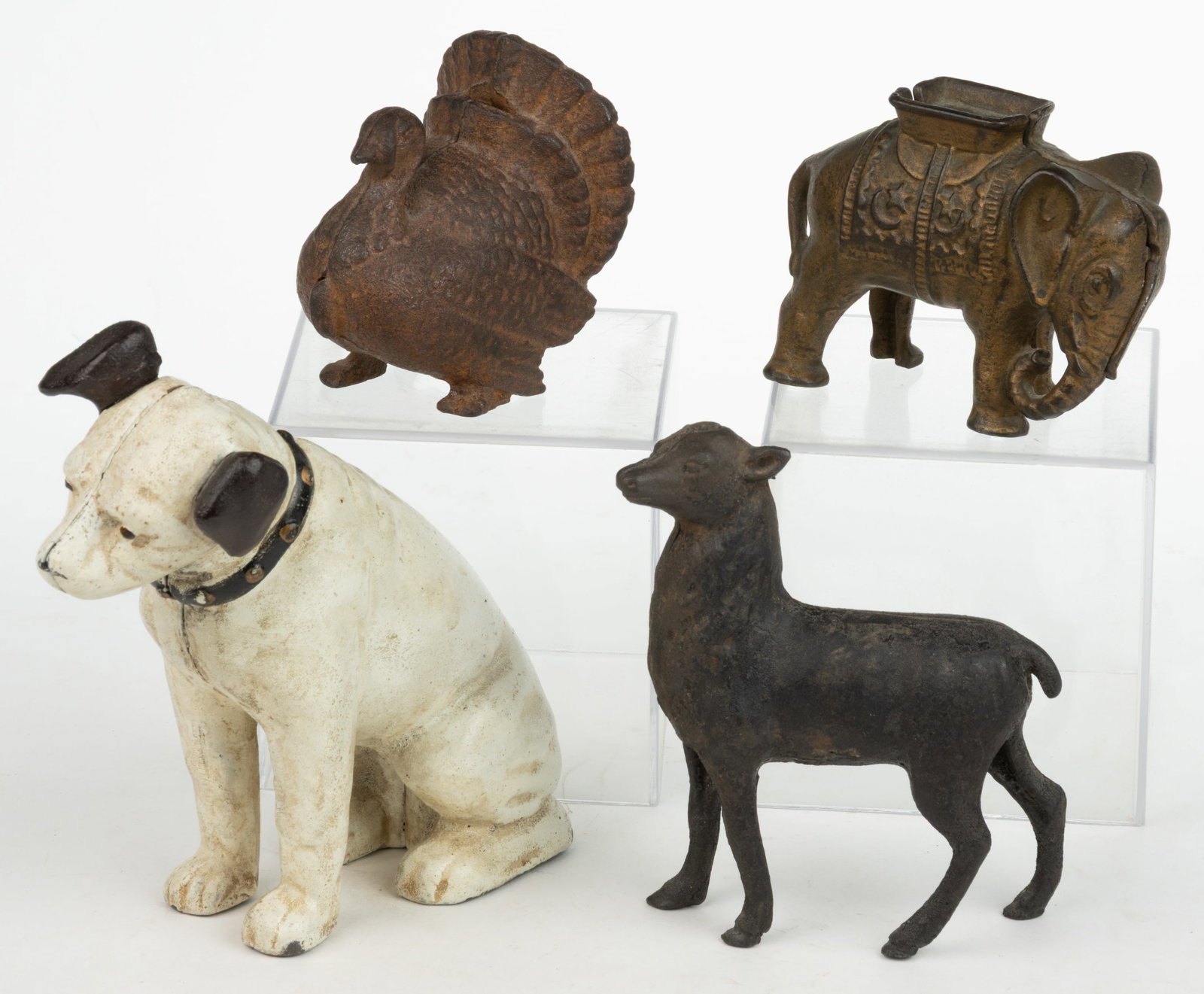 ASSORTED CAST-IRON FIGURAL STILL BANKS, LOT OF FOUR: ASSORTED CAST-IRON FIGURAL STILL BANKS, LOT OF FOUR, comprising a turkey, a deer, an elephant, and a reproduction Victor dog. The elephant, turkey, and dog retain their original painted surfaces, the 