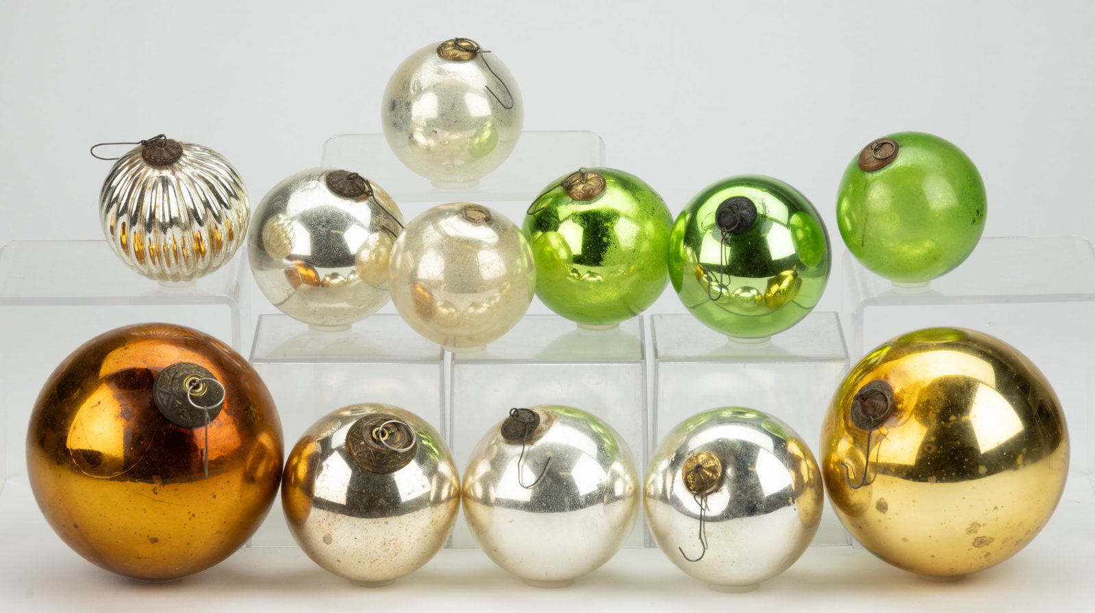 ANTIQUE GERMAN KUGEL CHRISTMAS ORNAMENTS, LOT OF 12: ANTIQUE GERMAN KUGEL CHRISTMAS ORNAMENTS, LOT OF 12, silver, amber, and green, all of free-blown spherical form except for one blown-molded ribbed example, most fitted with pressed-brass fixed caps, o