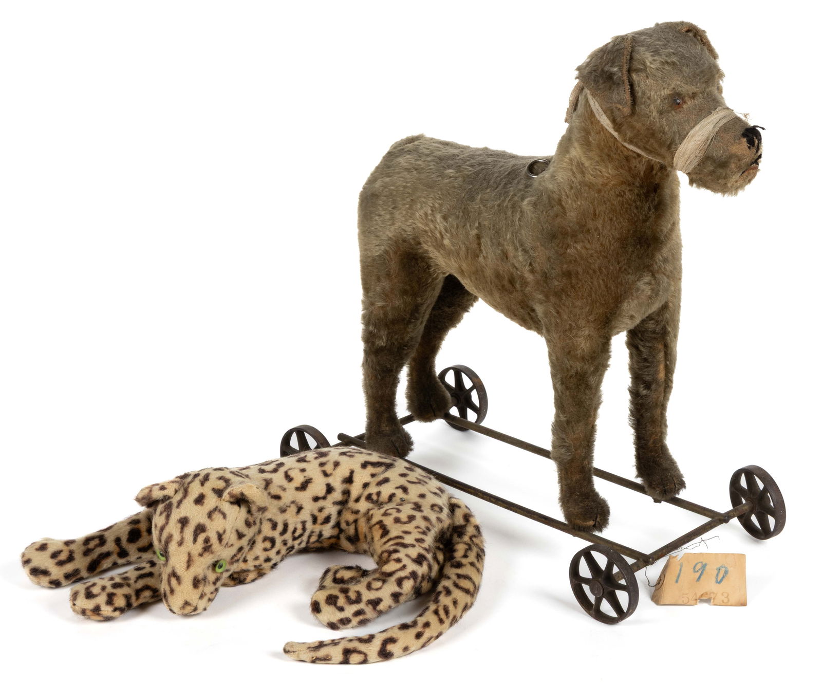 STEIFF TERRIER STUFFED MOHAIR DOG PULL TOY: STEIFF TERRIER STUFFED MOHAIR DOG PULL TOY, featuring glass eyes, a medium tan-colored body, a stuffed straw interior, pull-string which connects to possibly a squeaker, and an iron base with wheels.