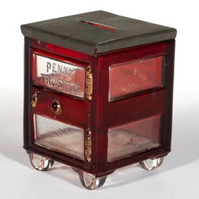 RUBY-STAINED PENNY TRUST CO. FIGURAL PRESSED GLASS STILL BANK / CANDY CONTAINER