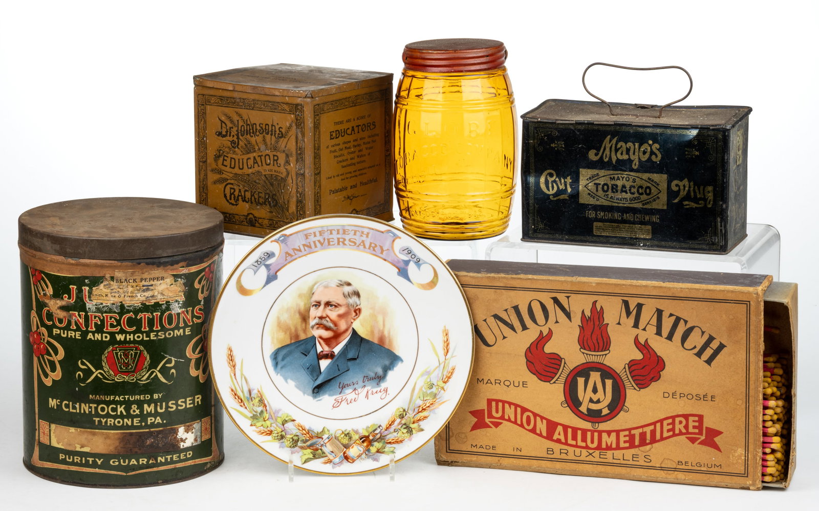 ASSORTED ADVERTISING BOXES, TINS, AND RELATED ARTICLES, LOT OF SIX: ASSORTED ADVERTISING BOXES, TINS, AND RELATED ARTICLES, LOT OF SIX, including a light yellow-amber glass barrel-form "GLOBE" tobacco jar with metal lid, a commemorative porcelain plate adver
