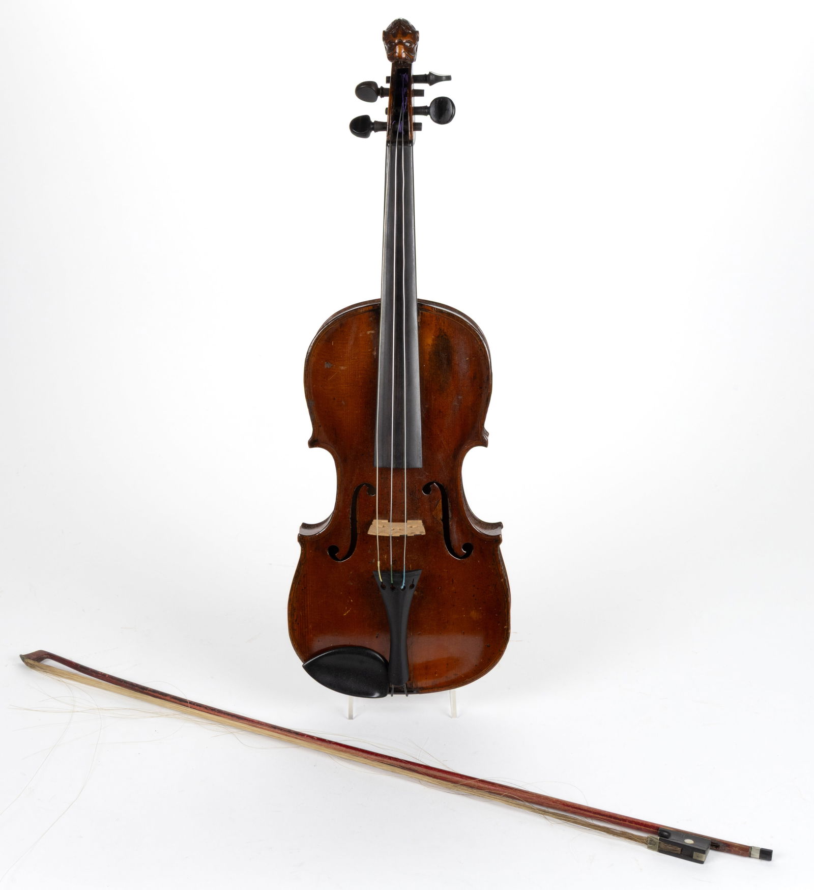 ANTIQUE / VINTAGE CARVED VIOLIN: ANTIQUE / VINTAGE CARVED VIOLIN, four string, maple and spruce, featuring a carved scroll of a lion's head, ebony fingerboard, tail piece, and chin rest. With an associated hardshell case and