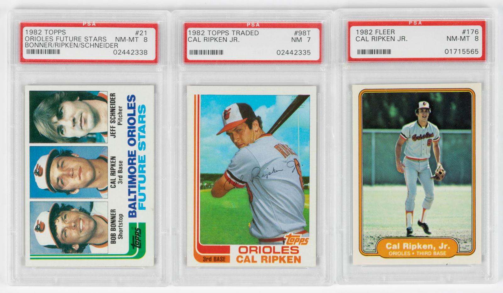 CAL RIPKEN JR. 1982 ROOKIE BASEBALL CARDS, LOT OF THREE PSA GRADED: CAL RIPKEN JR. 1982 ROOKIE BASEBALL CARDS, LOT OF THREE PSA GRADED, comprising Topps # 21 (NM-MT 8) and #98T (NM 7), and Fleer #176 (NM-MT 8). Each in a plastic case. Provenance: From the