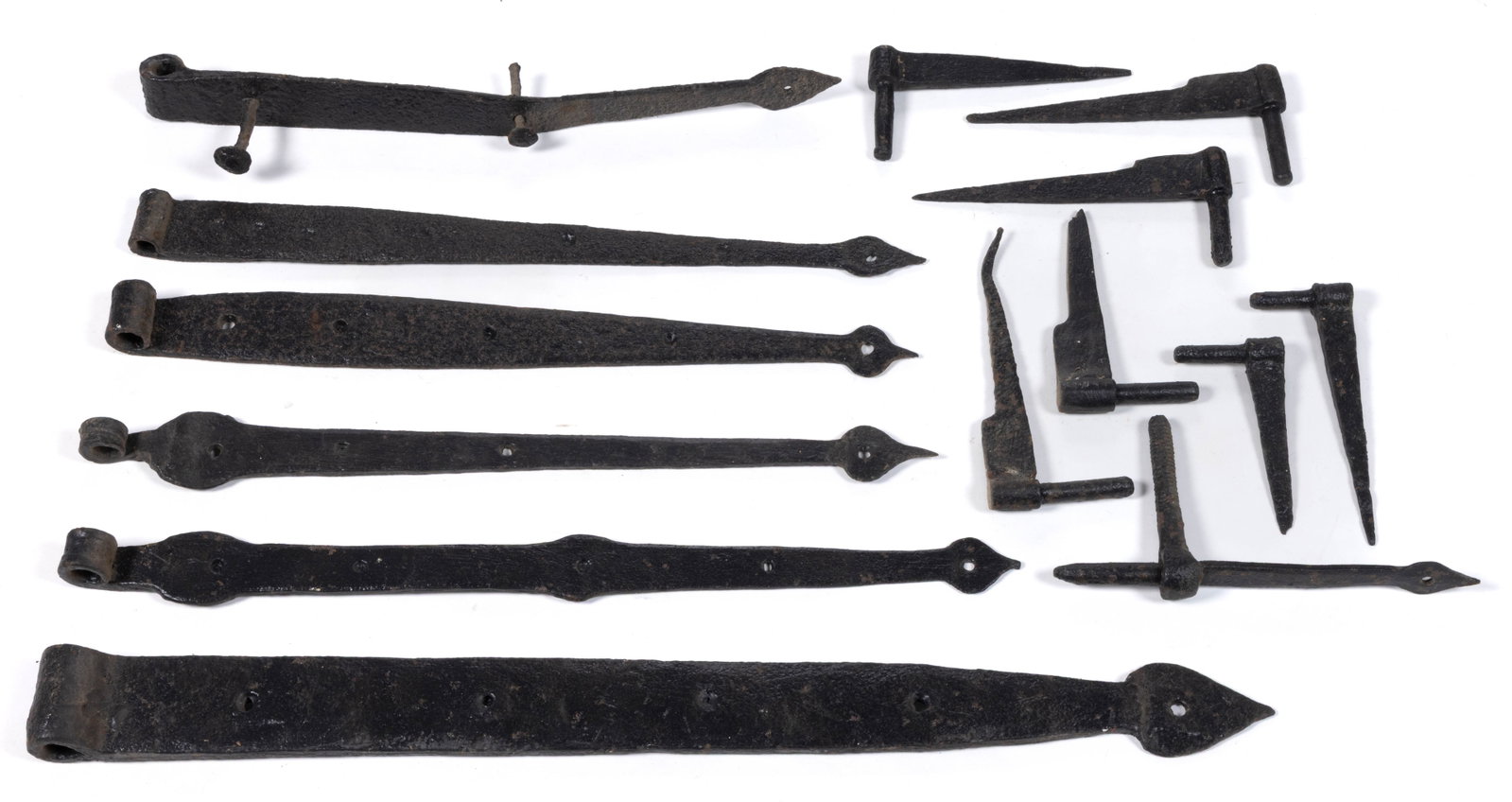 ASSORTED WROUGHT-IRON STRAP HINGES AND PINTLES LOT OF 14: ASSORTED WROUGHT-IRON STRAP HINGES AND PINTLES, LOT OF 14, comprising six hinges with tips terminating in a tulip-style; and eight pintles including one example with threaded bolt construction an