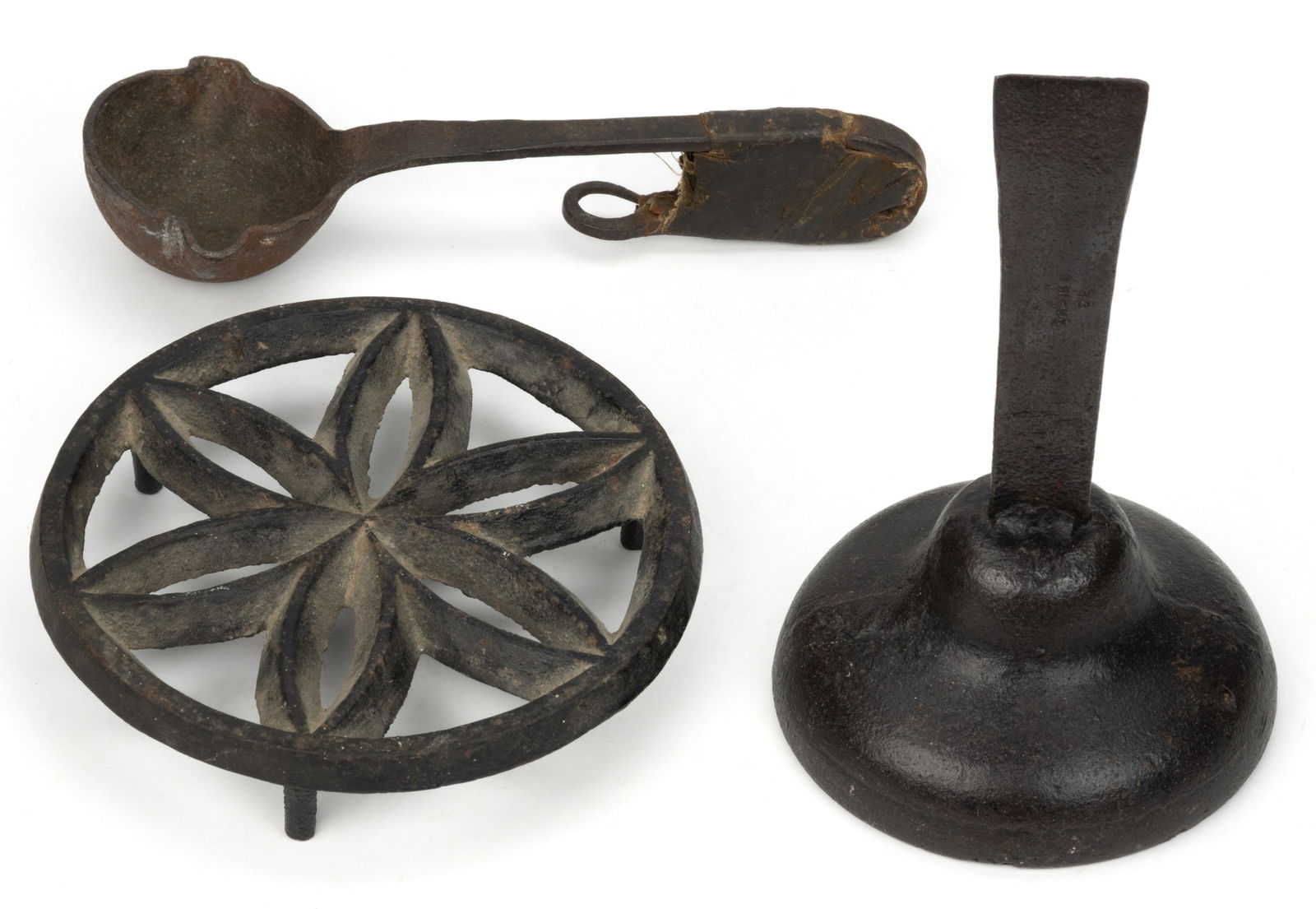 ASSORTED AMERICAN CAST-IRON ARTICLES, LOT OF THREE: ASSORTED AMERICAN CAST-IRON ARTICLES, LOT OF THREE, comprising a trivet with a pinwheel design; a wrought-iron ladle with a bent handle having some form of textile covering/heat sink; and what is, acc