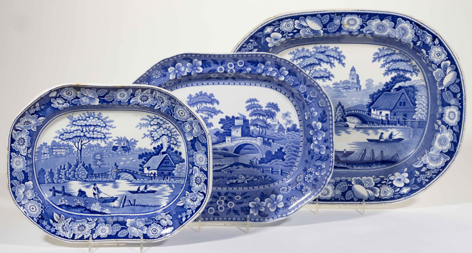STAFFORDSHIRE TRANSFER-PRINTED RURAL VIEWS CERAMIC PLATTERS, LOT OF THREE: STAFFORDSHIRE TRANSFER-PRINTED RURAL VIEWS CERAMIC PLATTERS, LOT OF THREE, each having dark blue transfer scenes with floral border decoration, comprising one Copeland example featuring "SPODE