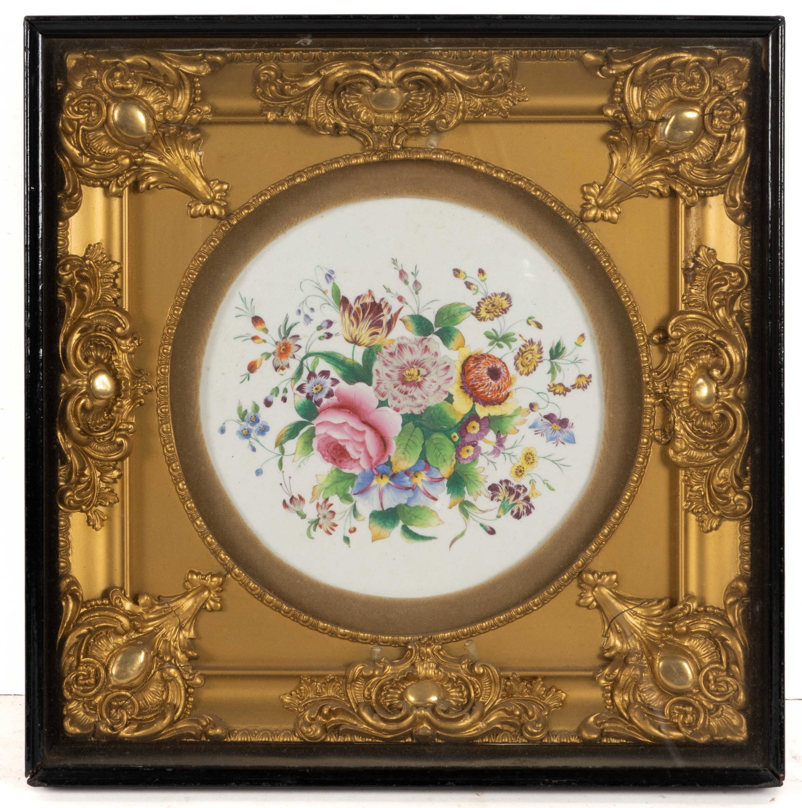 CONTINENTAL HAND-PAINTED FLORAL MOTIF PORCELAIN FRAMED PLAQUE: CONTINENTAL HAND-PAINTED FLORAL MOTIF PORCELAIN FRAMED PLAQUE, featuring a beautiful polychrome bouquet circular plaque. Housed under glass in a gilt gesso frame in the Grand Tour-style. Unmarked