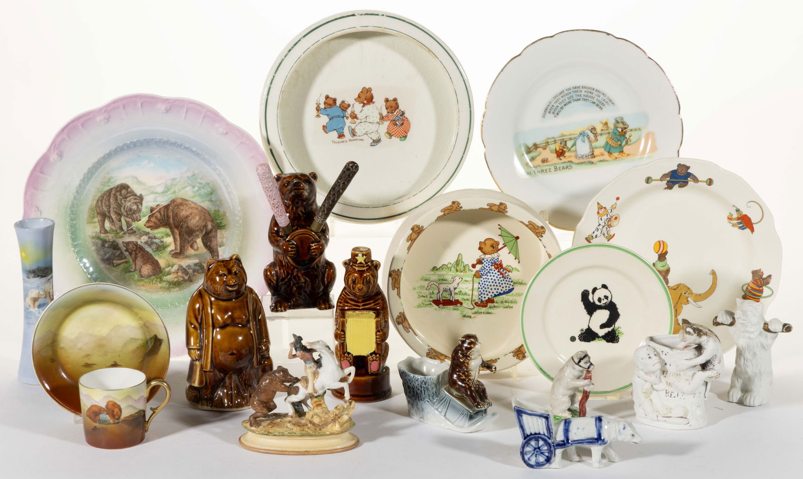 ASSORTED CERAMIC AND PORCELAIN BEAR MOTIF ARTICLES, LOT OF 17: ASSORTED CERAMIC AND PORCELAIN BEAR MOTIF ARTICLES, LOT OF 17, including two Royal Bayreuth examples including a polar bear bud vase and a child's cup and saucer set featuring brown bears, three b