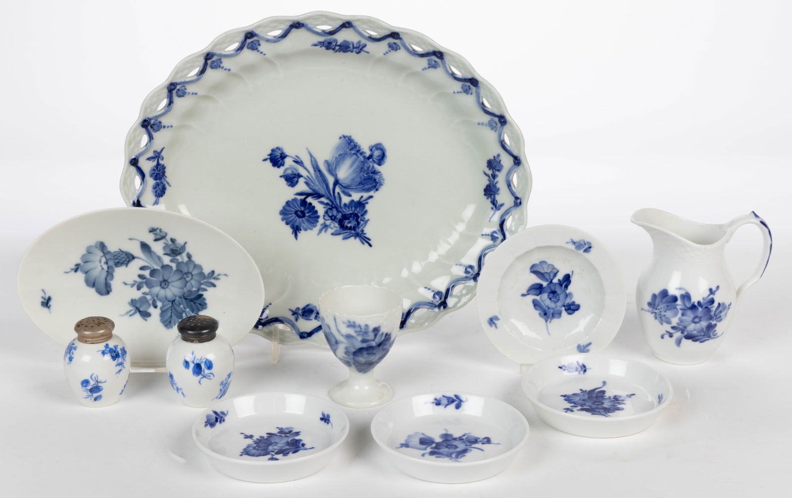 ROYAL COPENHAGEN AND OTHER PORCELAIN HAND-PAINTED BLUE FLOWER ARTICLES, LOT OF TEN: ROYAL COPENHAGEN AND OTHER PORCELAIN HAND-PAINTED BLUE FLOWER ARTICLES, LOT OF TEN, comprising eight examples including one ovoid reticulated rim platter, one footed egg cup, one 6 1/8"