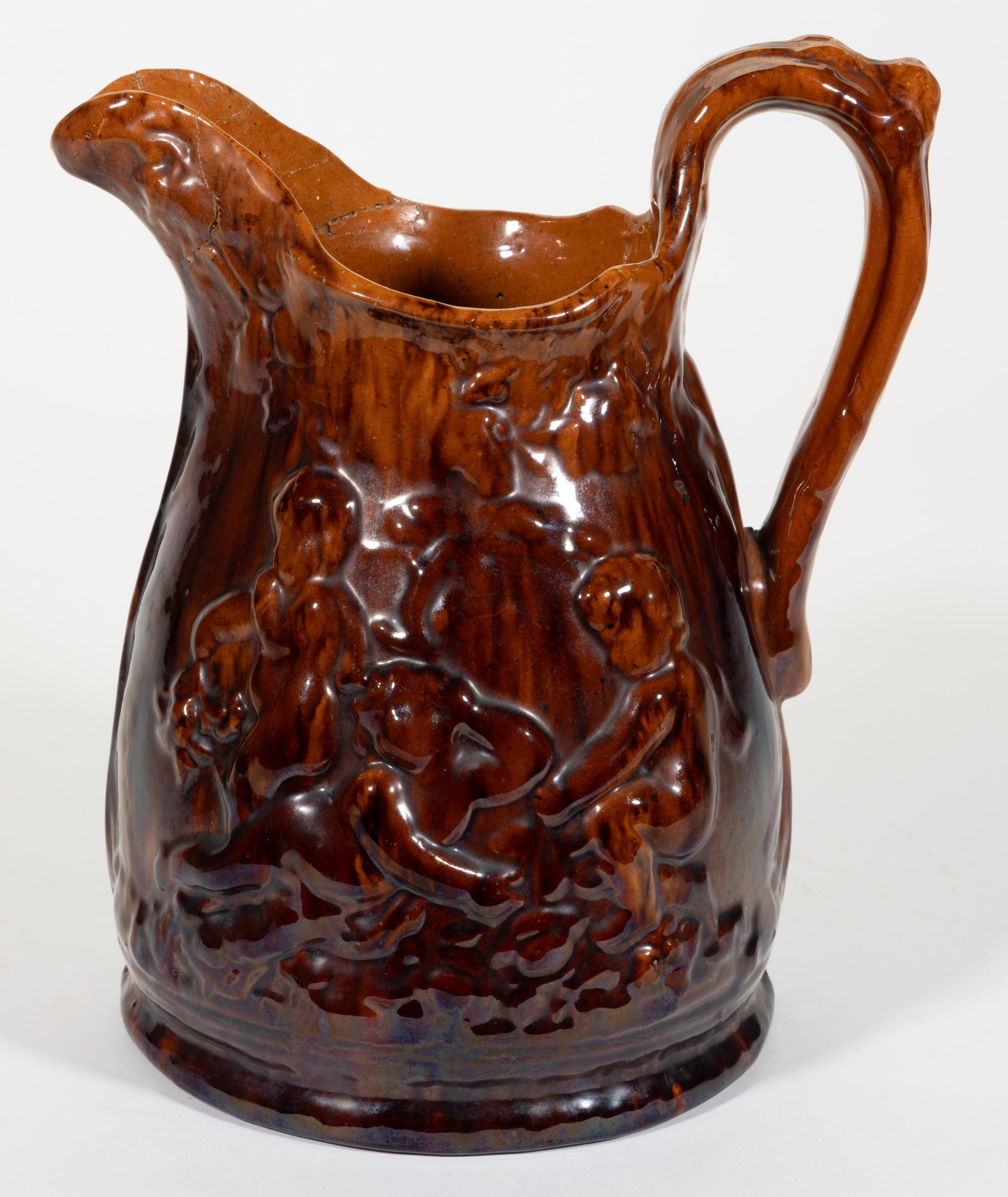 STAMPED "JOHN BELL / WAYNESBORO", PENNSYLVANIA EARTHENWARE / REDWARE PITCHER: STAMPED "JOHN BELL / WAYNESBORO", PENNSYLVANIA EARTHENWARE / REDWARE PITCHER, lead- and manganese-glazed, featuring embossed putti images to each side. John B. Bell (1800-1880), Waynesb