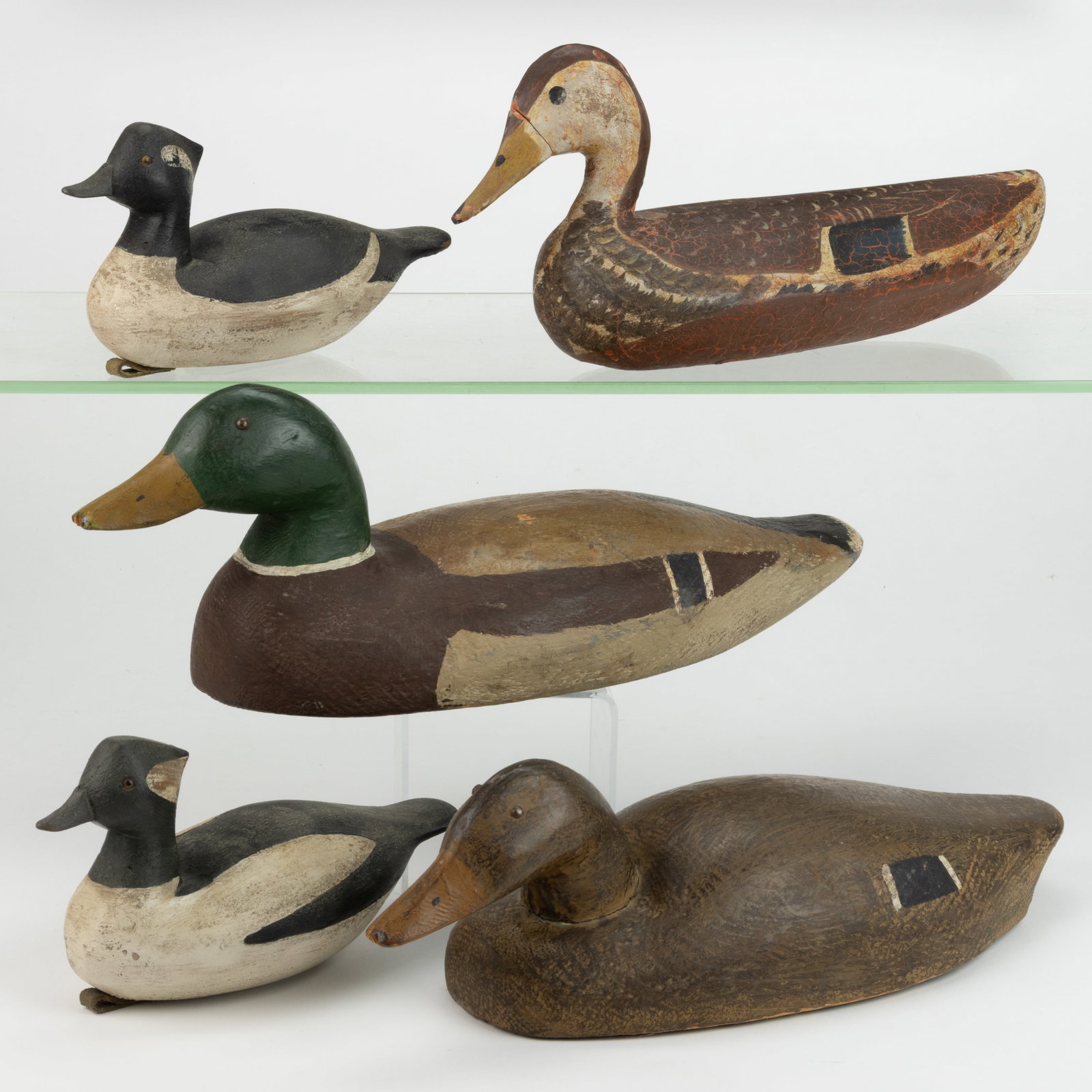 AMERICAN FOLK ART CARVED AND PAINTED DUCK DECOYS, LOT OF FIVE: AMERICAN FOLK ART CARVED AND PAINTED DUCK DECOYS, LOT OF FIVE, each retaining an old painted surface, the pair of birds branded "BC" to underside. 20th century. Largest example 6&q