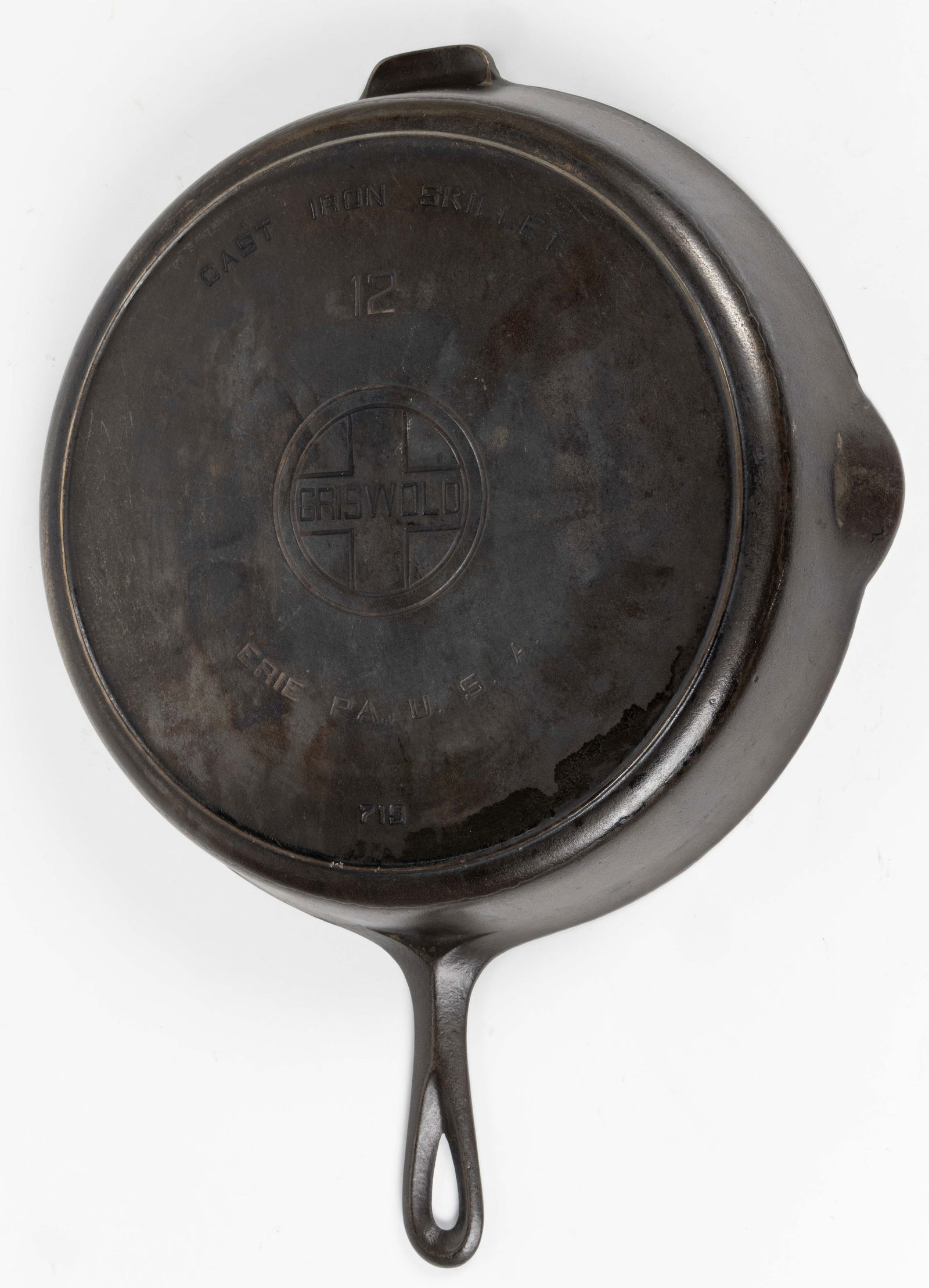 GRISWOLD CAST-IRON NO. 12 SKILLET: GRISWOLD CAST-IRON NO. 12 SKILLET, circular form with handle, two pour spouts and one side tab, underside with heat-ring bottom and impressed "CAST IRON SKILLET / 12 / ER