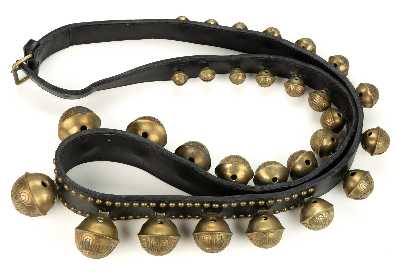 BRASS AND LEATHER STRAP OF SLEIGH BELLS: BRASS AND LEATHER STRAP OF SLEIGH BELLS, featuring 29 graduated bells, some numbered, mounted to a thick, likely original, leather strap which is decorated with brass buttons on the top side