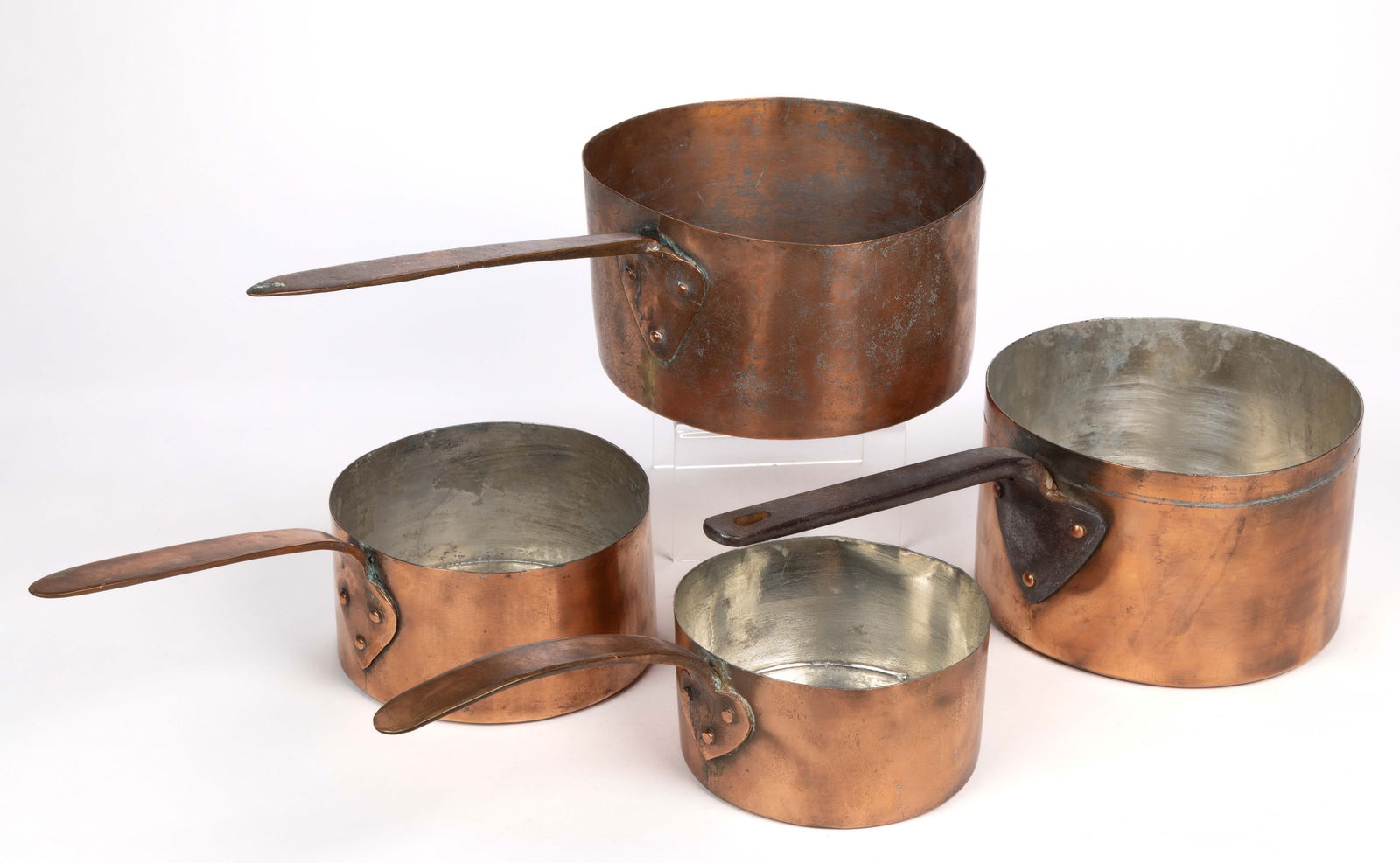 EUROPEAN COPPER SAUCEPANS, LOT OF FOUR: EUROPEAN COPPER SAUCEPANS, LOT OF FOUR, comprising a semi-graduated grouping of four straight-sided saucepans, three with copper or brass handles, one with an iron handle. Probably British. Late