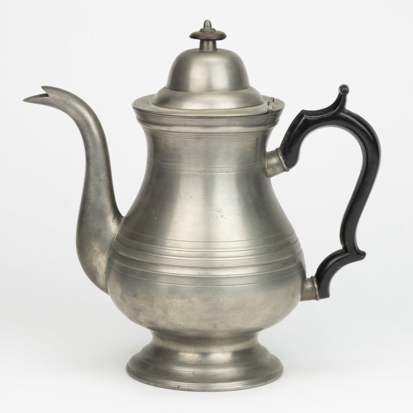 ASHBIL GRISWOLD, MERIDEN, CONNECTICUT PEWTER COFFEE POT: ASHBIL GRISWOLD, MERIDEN, CONNECTICUT PEWTER COFFEE POT, baluster form with black painted metal handle, body with groupings of horizontal lines, hinged cover, circular-form foot with underside impress