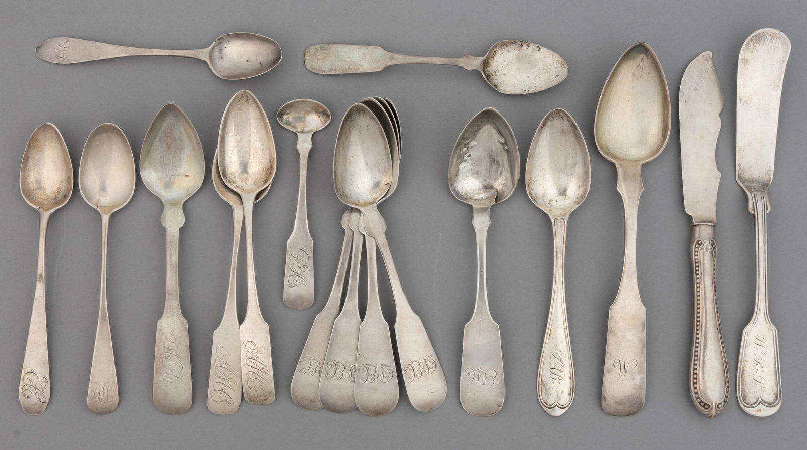 AMERICAN COIN SILVER SPOONS AND BUTTER KNIFES, LOT OF 17: AMERICAN COIN SILVER SPOONS AND BUTTER KNIFES, LOT OF 17, most with fiddle handles, each piece with a personalized engraving, including a marked 0.896 silver soup/dessert spoon by Andrew Ellicott Warn