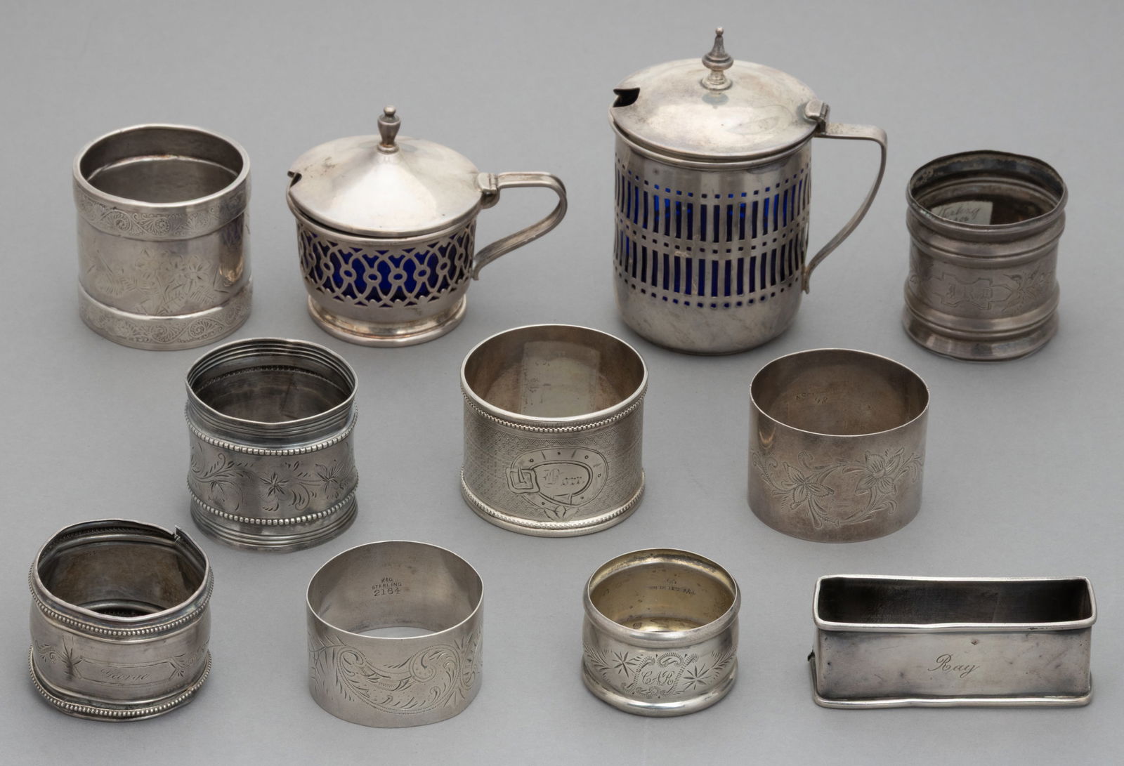ASSORTED STERLING AND OTHER SILVER NAPKIN RINGS AND MUSTARD POTS, LOT OF 11: ASSORTED STERLING AND OTHER SILVER NAPKIN RINGS AND MUSTARD POTS, LOT OF 11, comprising nine napkin rings with each having a personalized engraving consisting of six marked sterling pieces including t