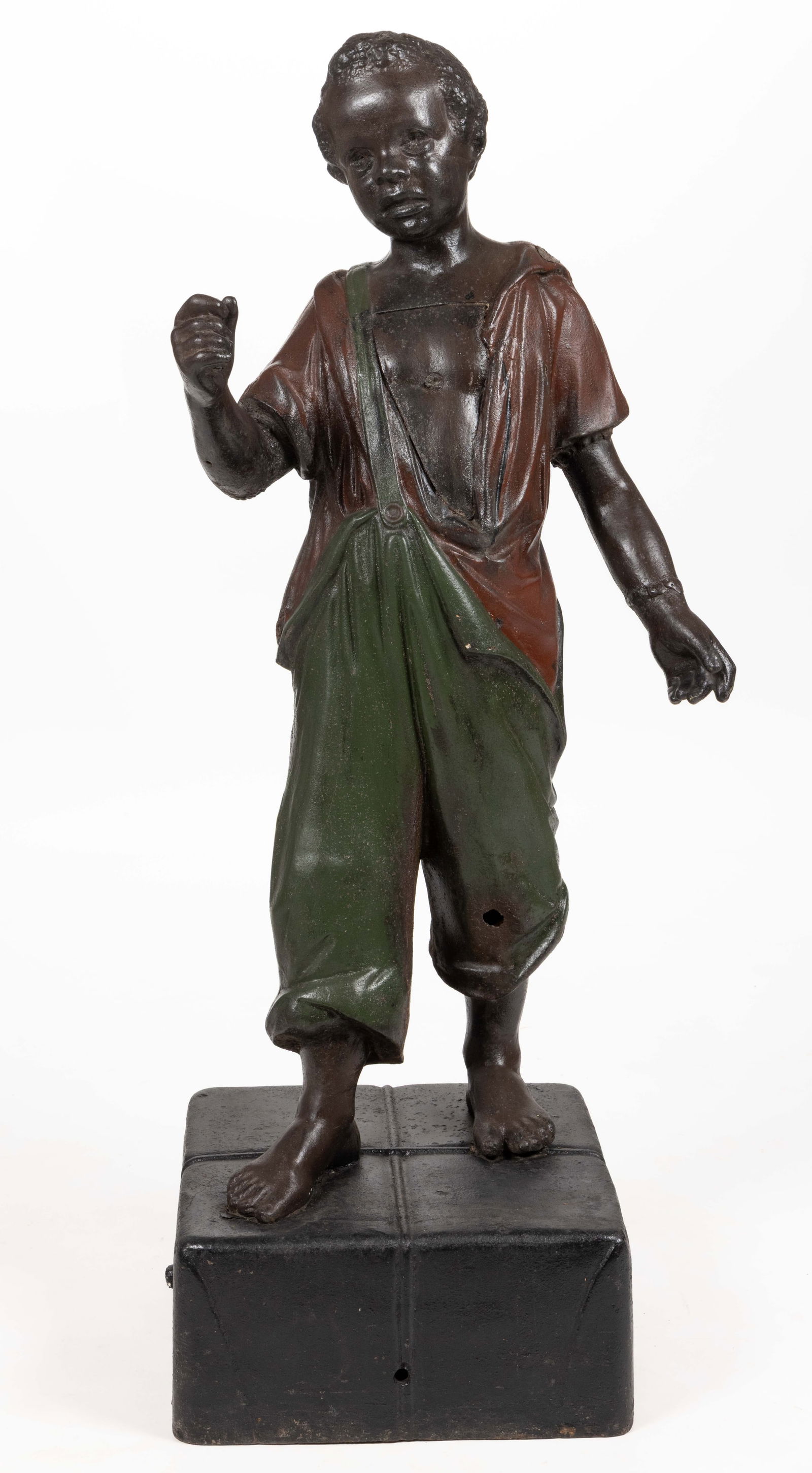 J. L. MOTT "FAITHFUL GROOMSMAN" (OMN) CAST-IRON BLACK AMERICANA FIGURAL HITCHING POST: J. L. MOTT "FAITHFUL GROOMSMAN" (OMN) CAST-IRON BLACK AMERICANA FIGURAL HITCHING POST, hollow-form, depicting a young enslaved boy standing atop a parcel, likely cotton, tied with strin