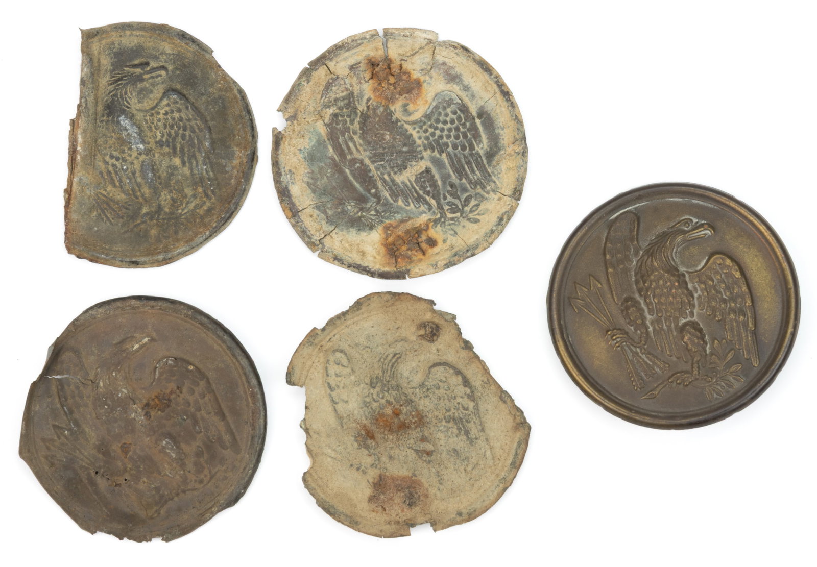 CIVIL WAR UNION EXCAVATED EAGLE BREASTPLATES, LOT OF FIVE: CIVIL WAR UNION EXCAVATED EAGLE BREAST PLATES, LOT OF FIVE, lead-filled stamped brass, each of circular form. Comprising one example with intact back including two eyelets, recovered at Frederick