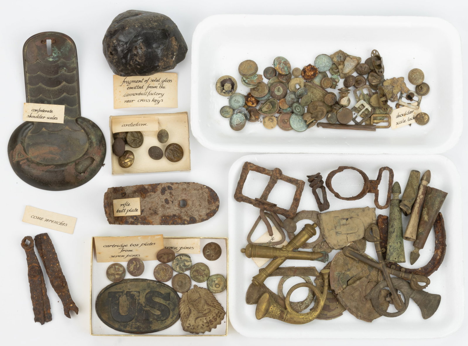 CIVIL WAR CONFEDERATE AND UNION EXCAVATED ARTIFACTS, UNCOUNTED LOT: CIVIL WAR CONFEDERATE AND UNION EXCAVATED ARTIFACTS, UNCOUNTED LOT, including shoulder scales, cone wrenches, cartridge box plates, buttons, various insignia, etc. Some identified as from Seven Pines,